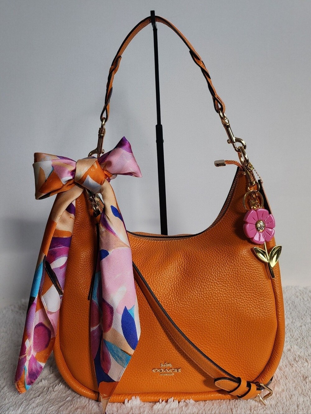 Coach Orange Leather Hobo Bag with Floral Charm